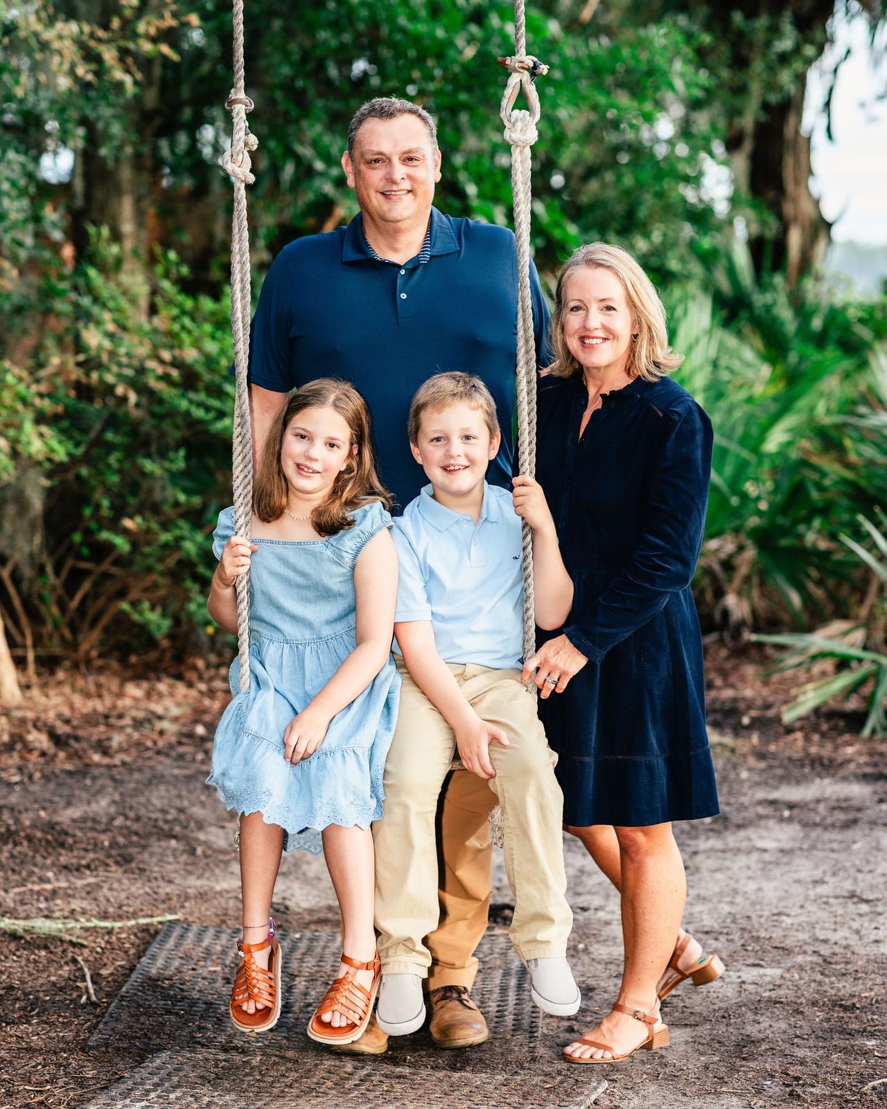 Kate Nolan with her husband and their two children on a rope swing